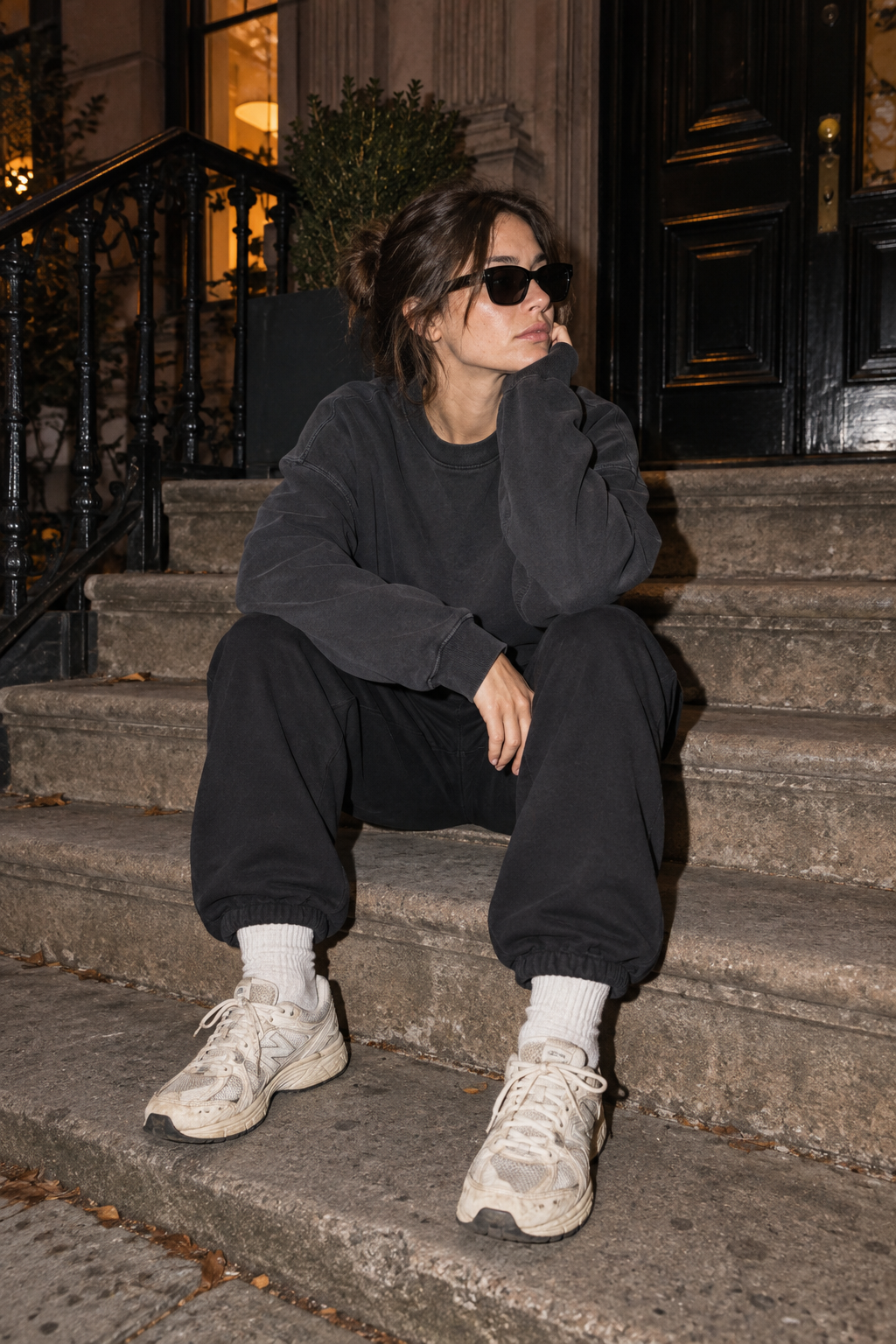 Off-duty charcoal sweatshirt and sneakers on city steps